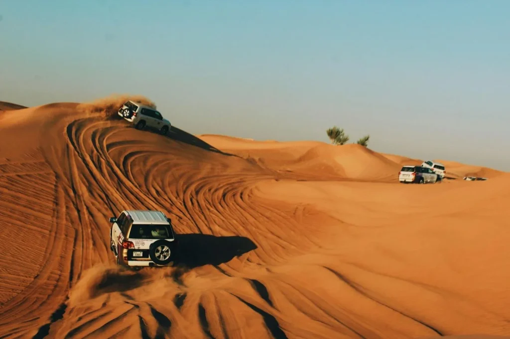 Five jeeps in the desert 
