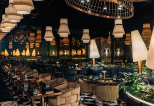 Elegant fine dining restaurant in Dubai with ambient lighting, plush seating, and a stylish interior perfect for business meals and refined dining experiences.
